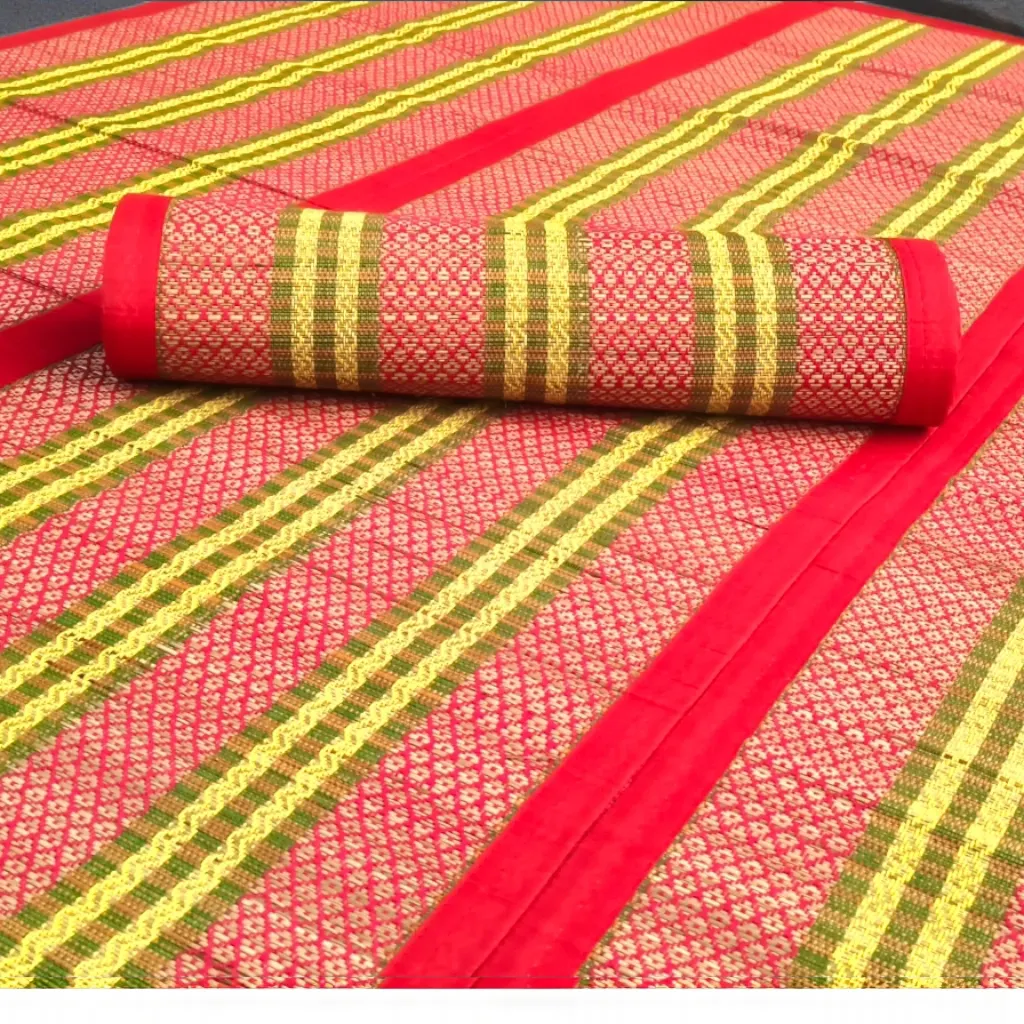 Close-up of Handwoven Korai Grass Madur Mat with Red Border and Traditional Gold Pattern – Eco-Friendly Handmade Mat by Bhumikart